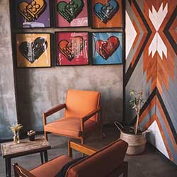 Chairs arranged next to each other with lego heart pieces decorating wall